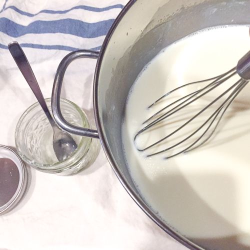 Wisking the starter culture into milk for homemade yogurt