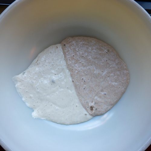 A bowl with white and whole wheat sourdough starter.