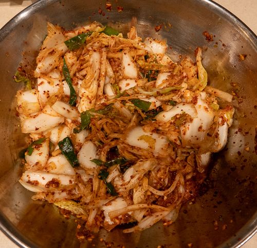 Mixing the kimchi paste with the cabbage